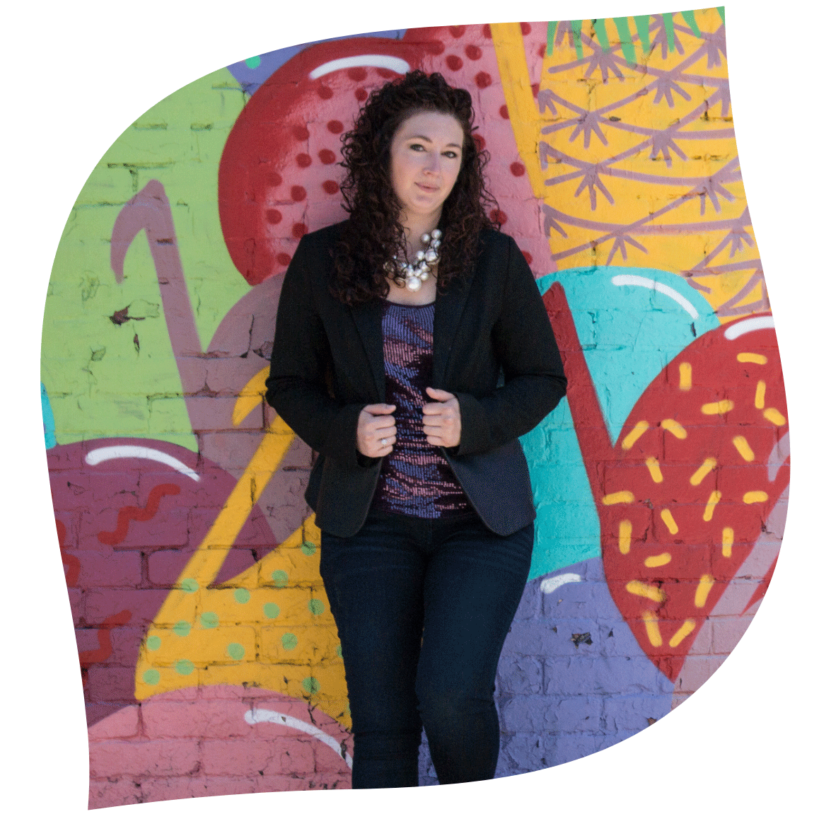 Founder and Brand Builder Courtney Conley in front of mural in Eastern Market, Detroit Michigan